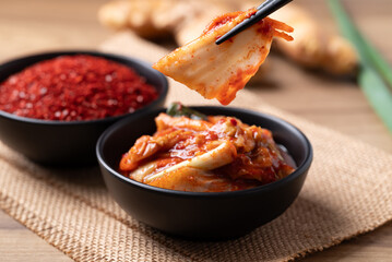 Kimchi cabbage in a bowl with chopsticks, Korean food
