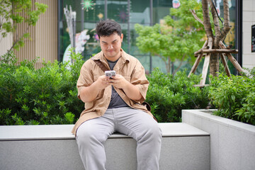 An individual demonstrates digital engagement within an urban setting, highlighting the intersection of technology and modern life.