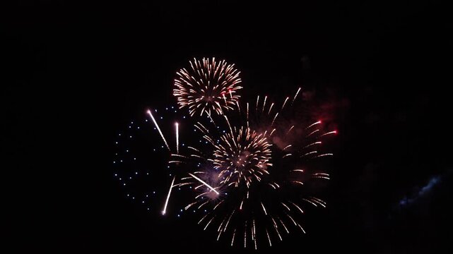 Colorful fireworks lighting up the night sky over the river during a festive celebration