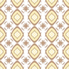 Fototapeta premium Seamless ikat pattern in ethnic boho style with geometric diamond shapes and tribal motifs on cream background. Traditional textile design for fashion, wallpaper, and home decor.