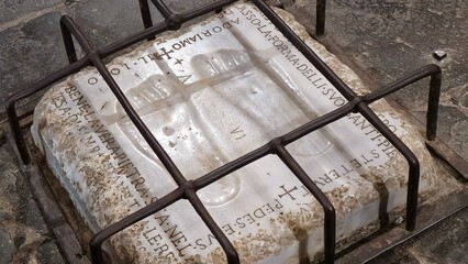 Rome, Italy &ndash; 14 January 2025. A marble stone with imprinted footprints, traditionally linked to Jesus, lies protected by iron bars inside the Church of Domine Quo Vadis.