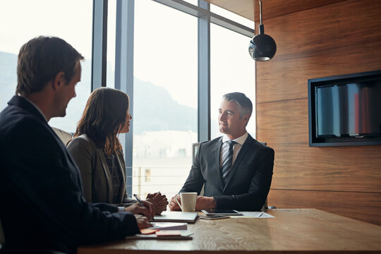Business, men and woman in office for legal advice, consultation or corporate negotiation with attorney. Advisor, lawyer team and people in meeting at law firm for discussion, interview or networking