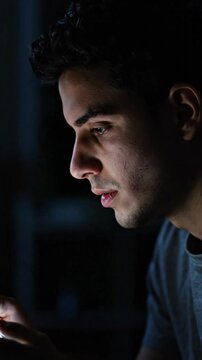 Young man suffers eye strain from smartphone blue light late night