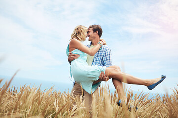 Carry, couple and smile in wheat field for support, travel and date with space on holiday. Romance,...