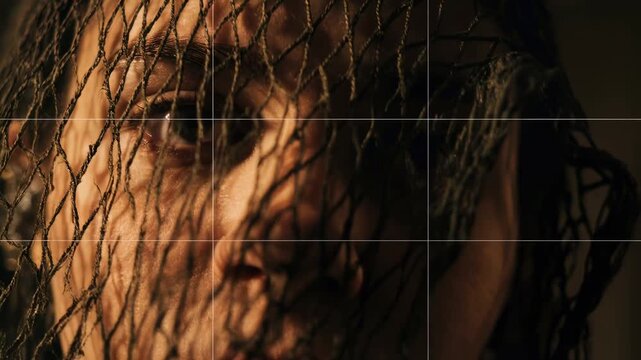Money dysmorphia concept -  a close-up eye peers through tight mesh with a stylized dollar symbol, blending finance and surveillance themes