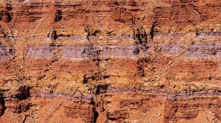 Fototapeta premium Telephoto detail view of colorful sedimentary sandstone rock layers texture