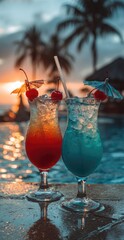 Two vibrant cocktails, red and blue, adorned with cherries and paper umbrellas, sit by a pool at sunset.