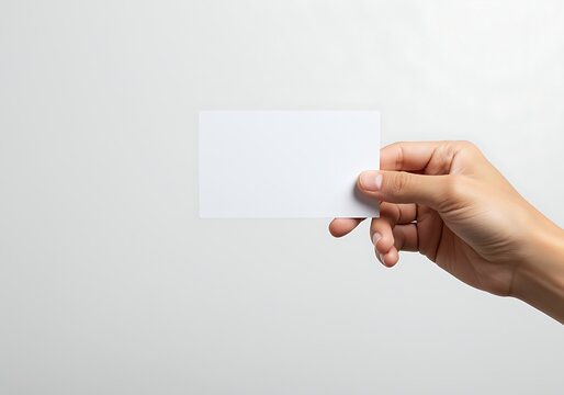hand holding blank white business card on white background