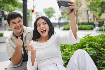A young couple utilizes digital mapping to navigate a metropolitan area, illustrating modern travel and connectivity.
