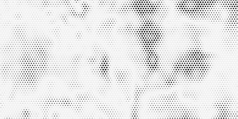 Black and white halftone spotted background. Gray color sports clothing fabric texture and textile background. Black dots on a gray background. Close-up of a offset printed poster.
