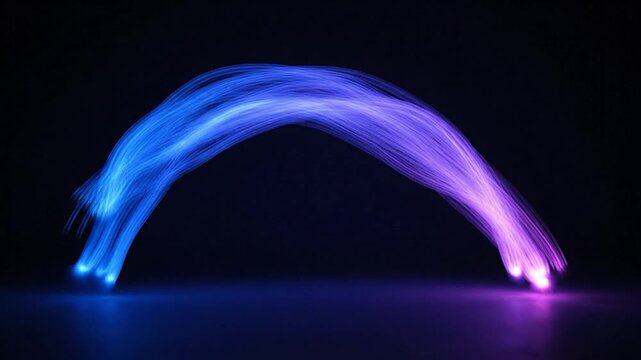 A vibrant, arching streak of glowing blue to purple light against a dark background
