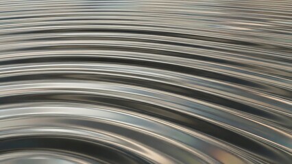 Concentric Ripples on a Polished Silver Metallic Surface Creating Circular Liquid Waves