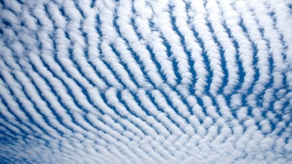 Serene blue sky with altocumulus clouds in wavy pattern