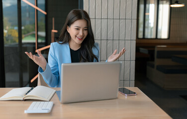 Asian businesswoman presenting ideas and analyzing financial charts during an online meeting.