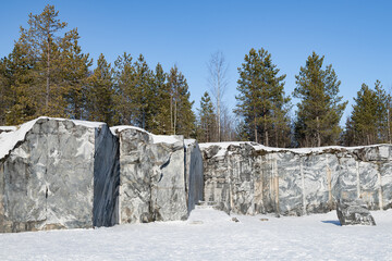 Fragment of cut marble rock in the old Italian marble quarry. Ruskeala Mountain Park. Karelia, Russia