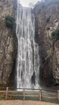 Wenzhou, Zhejiang, China - January 1 2026: A majestic view of the first fall of Baizhangji Waterfall in Wencheng County. A massive column of water plunges 207 meters down a sheer vertical rock face in