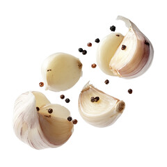 Garlic cloves and peppercorns floating isolated on a transparent background