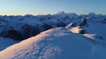 Snow covered mountain range landscape aerial view during daytime