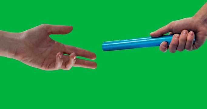 Close up view of hand passing a baton against black background
