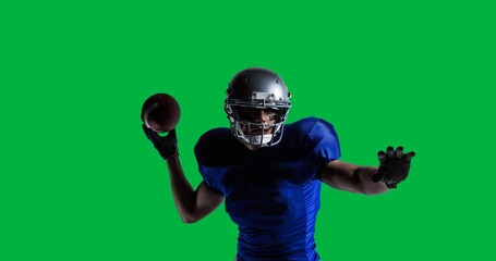 African american male rugby player wearing helmet holding rugby ball against black background - Powered by Adobe
