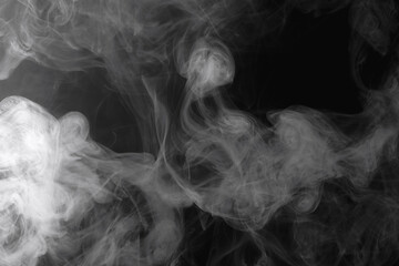 Wisps of white smoke isolated on a black background with space for text