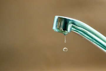 Leaking faucet dripping water droplets