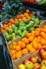 Fresh fruits display, oranges, pears, apples in cardboard boxes