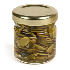 Glass Jar of Pumpkin Seeds Preserved in Honey Isolated on White