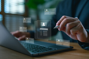 Businessman reviewing digital resumes with virtual interface, illustrating online recruitment, candidate evaluation, HR analytics, and smart hiring technology in modern human resources.