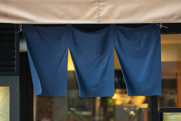 The curtain-like fabric that hangs in front of traditional Japanese restaurants and shops not only serves as a signboard, but holds a larger meaning,