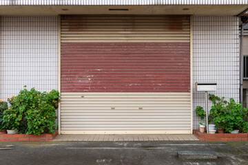 A closeup shot of automatic metal roller door used in factory, storage, garage, and industrial warehouse. The corrugated and foldable metal sheet offer space saving and provide urban and rustic feel