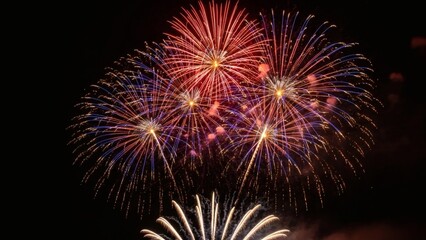 Fototapeta premium Explosion of Vibrant Colors in a Night Sky Display Stunning Fireworks Illuminate the Darkness with Dazzling Light Shows