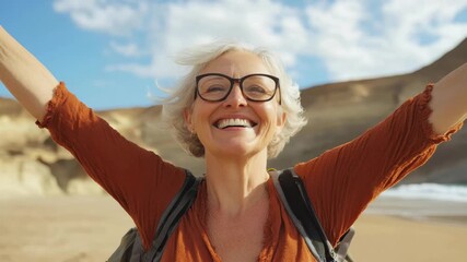 Joyful woman celebrating at the beach during a sunny day with arms raised in happiness