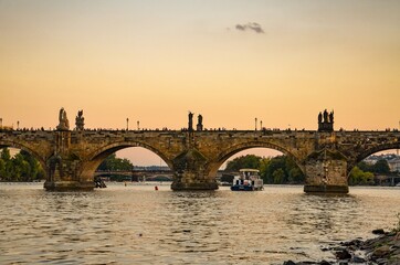 Obraz premium Czech Republic, Prague September 6, 2025, The Charles Bridge in Prague is undoubtedly one of the most popular bridges in Europe, and behind it, Prague Castle, towering over the Vltava River