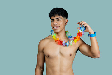 Shirtless young man wearing colorful lei smiling and looking away