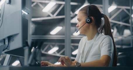 Specialist Manages Network Systems From Workstation in Network Operations Center. Woman Wearing...