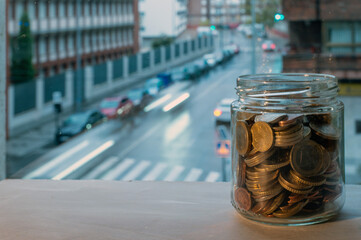 Jar Of Coins On Window Sill Overlooking Rainy City Street And Crosswalk