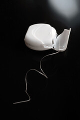 dental floss on black background
