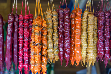 Traditional Georgian Churchkhela Sweets Hanging in a Row at a Market