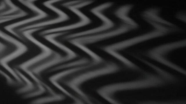 Abstract black and white moving zig-zag lines texture, waves background for music and art concepts with flowing cloth effect