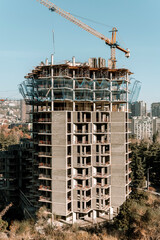 Construction of a building. Construction site with crane. Business, development, industry.