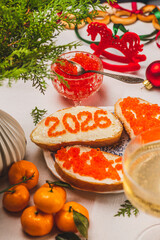 A sandwich with butter and caviar. The figures for 2026 are laid out in dots.