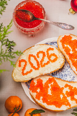 A sandwich with butter and caviar. The figures for 2026 are laid out in dots.
