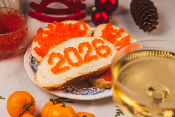 A sandwich with butter and caviar. The figures for 2026 are laid out in dots.