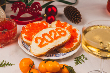 A sandwich with butter and caviar. The figures for 2026 are laid out in dots.