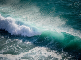 Ocean wave cresting with powerful turquoise water