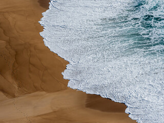 Ocean waves crashing on a sandy beach