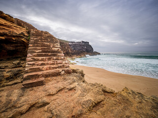 Stone stairs leading to Nazar&eacute; beach and Atlantic Ocean
