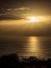Golden sunset light reflecting on Atlantic Ocean at Nazar&eacute;