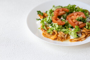 Close-Up of Chicken Kapsalon with Turkish Doner on White Plate